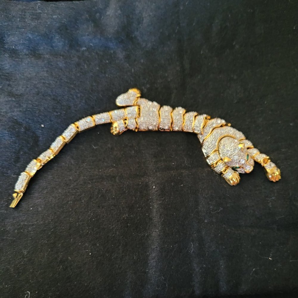 Stunning gold tone leopard rhinestone bracelet with green eyes.